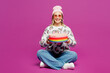 © ViDi Studio - Full body young happy lesbian woman wears pink animal clothes hold in hand birthday cake with candles making wish isolated on plain purple background studio. Pride day June month love LGBTQ concept.