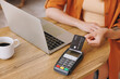 © ViDi Studio - Close up woman hold bank payment terminal to process acquire credit card pay bill sitting alone at table in coffee shop cafe relax rest at restaurant indoor. Freelance mobile office business concept.