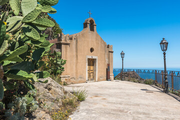 The old church of San Biagio and the prickly pears growing next it, front view, Castelmola, Sicily, Italy