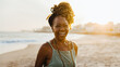 © (JLco) Julia Amaral - Happy senior African American woman with braids smiling at the beach during sunset