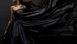 © Ranju - Man and woman in black silk dress, flowing fabric, elegant pose, dark background, closeup