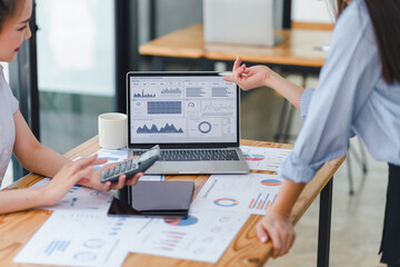 professional analyzing financial data graphs, charts on laptop display at a modern workspace. financ