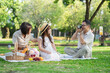 © PRIME STOCK LAB - Family Enjoying Picnic and Taking Photos in Park.