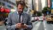 © Pist L. - Businessman in suit using smartphone. Urban street scene with blurred traffic background. City lifestyle and busy professional concept.