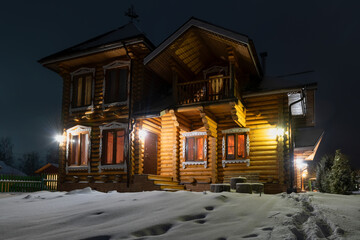 Wall Mural - Wooden house in the village on a cold winter night, after a snowfall