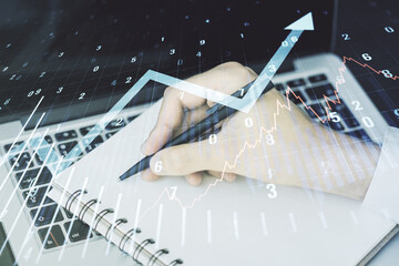 Poster - Abstract creative financial graph with upward arrow and hand writing in diary on background with laptop, financial and trading concept. Multiexposure