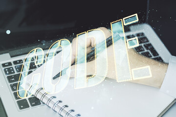 Aufkleber - Creative Code word sign and hand writing in notepad on background with laptop, international software development concept. Multiexposure