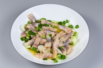 Wall Mural - Sliced pickled atlantic herring with chopped green onion on dish