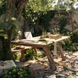 © Visit - A serene outdoor scene with a wooden table and chairs set amidst a lush garden and park setting, surrounded by nature's beauty