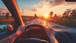 © Sergej Gerasimov - Hands of driver on wheel for summer road trip at sunset, a scenic vacation drive experience