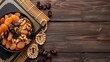 © JP STUDIO LAB - Ramadan iftar party setting, Islamic holy book Quran and rosary beads placed beside a platter of dates, dried figs, apricots, walnuts, almonds, and raisins on a bamboo mat