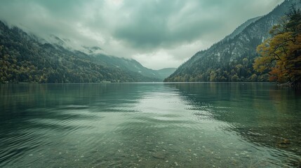 Lake with green water beneath overcast sky