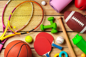 Wall Mural - Different sports equipment on wooden background top view