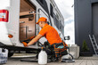 © Tomasz Zajda - Camper Rentals Worker Cleaning RV Interior With Vacuum