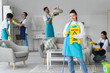 © Pixel-Shot - Female janitor with mop and caution sign in room