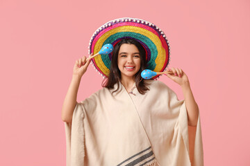 Canvas Print - Beautiful young happy woman in sombrero with maracas on pink background. Cinco de Mayo celebration