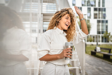 Adult business woman stand hold thermos cup and send greetings