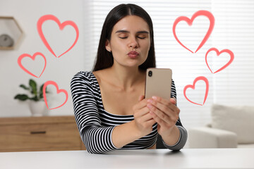 Sticker - Long distance relationship. Young woman sending air kiss to her loved one via video chat indoors. Red hearts around