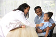 © offsuperphoto - asian doctor holding stethoscope and listening to African child patient's breath beside her father in the clinic