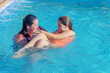 © JOSEANTONA - a mother holds her beautiful daughter in her arms teaching her to swim in the pool