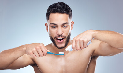 Canvas Print - Man, toothbrush and surprised with toothpaste in studio for oral hygiene, mouth cleaning and morning routine. Dental, person and brushing teeth for fresh breath and healthy gums on gray background