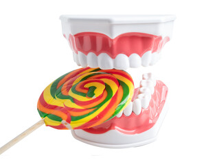 tooth decay model with colorful candy sweet food on white background with copy space.