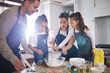 © peopleimages.com - Family, children and baking in kitchen with food for helping and teaching cake recipe in home. Mom, dad and kids with cooking cookies or bread together for learning and relationship bonding with love