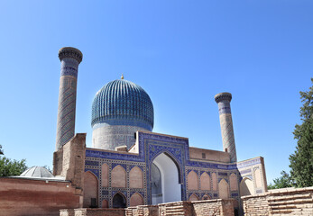 Sticker - Famous landmark Gur Emir Mausoleum in Samarkand, Uzbekistan. Exterior of tomb of Amir Timur Tamerlan. Mosaic arch entrance, minarets and dome of Gur-e-Amir mausoleum of turco-mongol conqueror Timur