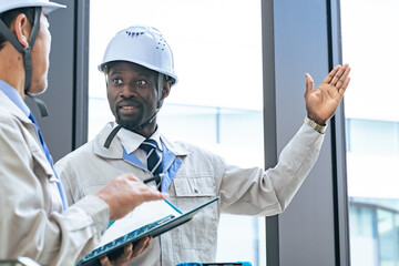 Poster - Group of multinational engineers having a conversation in a building