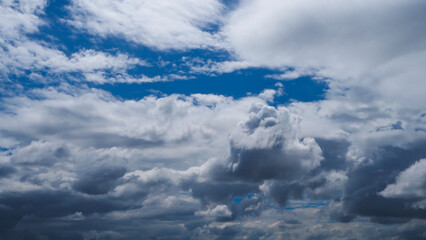 Wall Mural - A blue sky with white clouds is adorned with a brilliant shade of blue, adorned with puffy, fluffy white clouds.