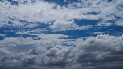 Wall Mural - A blue sky with white clouds is adorned with a brilliant shade of blue, adorned with puffy, fluffy white clouds.