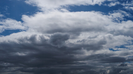 Wall Mural - A blue sky with white clouds is adorned with a brilliant shade of blue, adorned with puffy, fluffy white clouds.