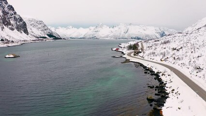 Wall Mural - 4k drone forward video (ultra high definition) of lofoten islands with huge snowy peaks on backgroun