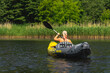© Dmitri - A girl kayaking on an inflatable boat on a summer day, view from the back.
