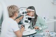 © Westend61 - Ophthalmologist using optical instrument for checking girl's eyes