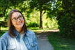 © Westend61 - Happy woman wearing eyeglasses and standing in park