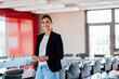 © Westend61 - Smiling businesswoman holding smart phone in meeting room at office