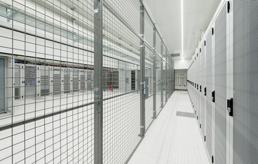 Illuminated server room with fence at data center