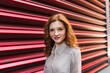 © Westend61 - Beautiful redhead woman standing in front of corrugated iron