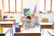 © Halfpoint - Schoolgirl, pupil sitting at desk in classroom at the elementary school. Student girl pen, writing in exercise book, notebook.