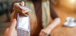 © Soloviova Liudmyla - Young woman holding credit doing wireless bank payment with POS terminal process acquire at table in coffee shop cafe restaurant indoor. Focus on machine. Finance, restaurant industry, small business.
