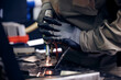 © Parilov - Worker use weld metal welding machine in workshop, blue sparks