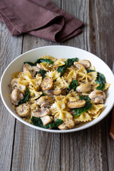 Wall Mural - Farfalle pasta with mushrooms and spinach. Healthy eating. Vegetarian food.