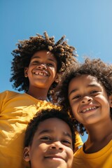 African American children with curly hair smile. Children against the background of the sky.