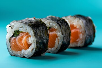 Wall Mural - Sushi Rolls with Salmon on Teal Background