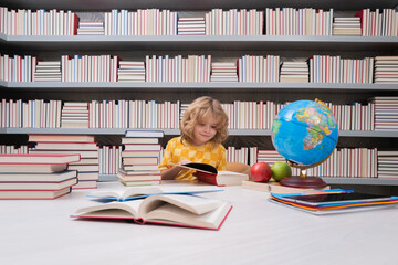 Fototapete - School and students in classroom. Education kids. Child pupil student in the school class. Studying and learning concept. School boy in the library near school supplies. Kid learn geography with globe