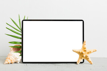 Wall Mural - Flat lay composition with tablet and beach accessories on colored background. Tablet computer with blank screen mock up with copy space