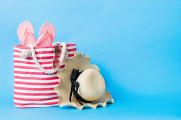Stylish bag with beach accessories . Summer holiday concept. beach bag with straw hat with space for text
