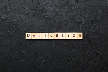 Wall Mural - Motivation word written on wood block. Motivation text on cement table for your desing, concept