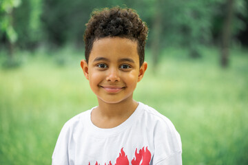 Wall Mural - Close up portrait of an eight year old mixed race boy, summer outdoor